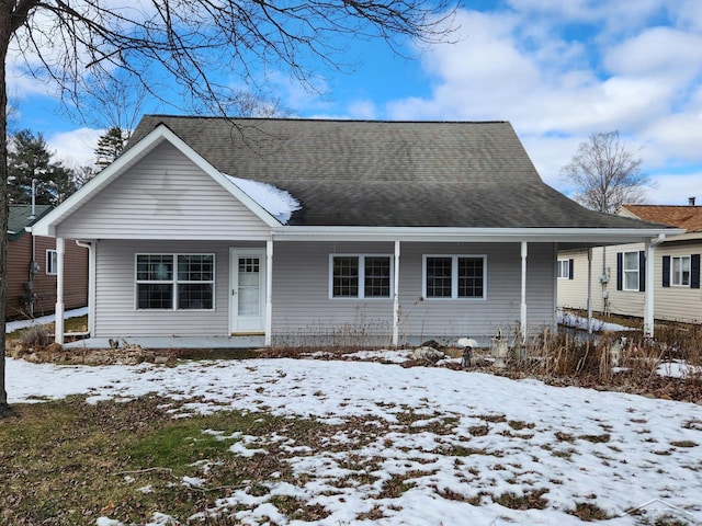 view of front of home with a porch and roof with shingles