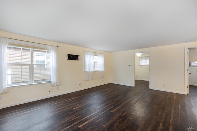 unfurnished room featuring dark wood finished floors and baseboards