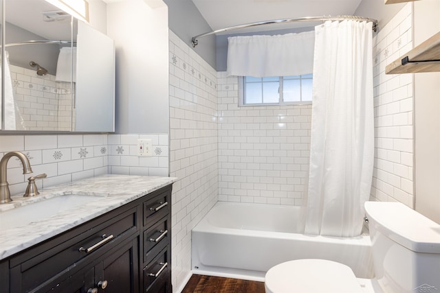 bathroom with vanity, wood finished floors, decorative backsplash, toilet, and shower / tub combo with curtain