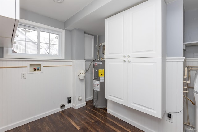 clothes washing area with cabinet space, water heater, electric dryer hookup, washer hookup, and dark wood-type flooring