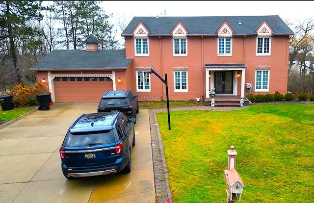 view of front of home with a front lawn and a garage