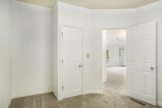 interior space with light colored carpet and crown molding