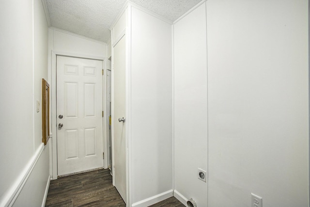 hallway featuring dark hardwood / wood-style floors and a textured ceiling