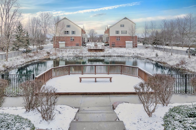 snow covered building featuring a water view