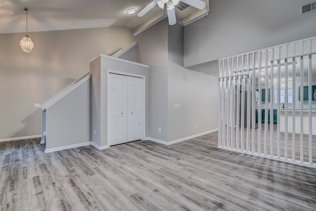 interior space featuring ceiling fan, lofted ceiling, and light wood-type flooring