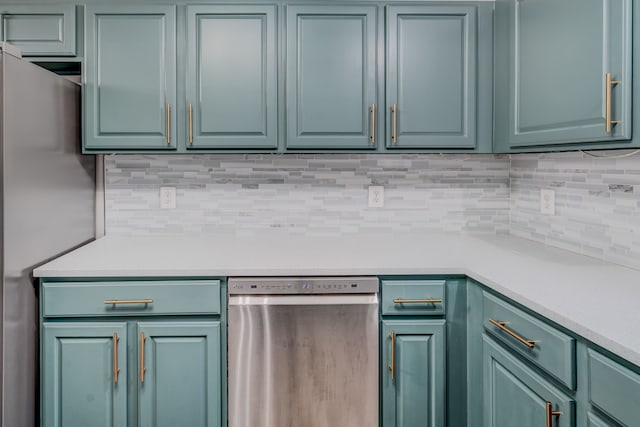 kitchen with stainless steel appliances and tasteful backsplash