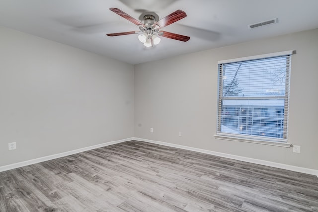 empty room with light hardwood / wood-style floors and ceiling fan