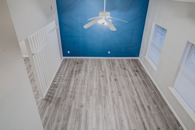 unfurnished room featuring ceiling fan, light hardwood / wood-style floors, and vaulted ceiling