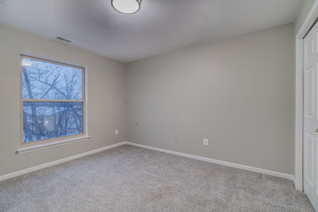 unfurnished room with light colored carpet