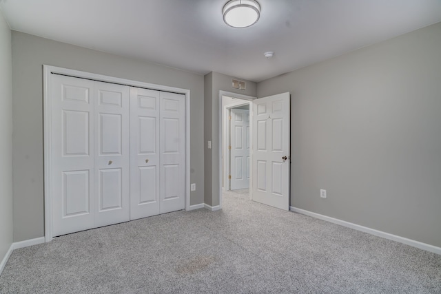 unfurnished bedroom featuring a closet and carpet