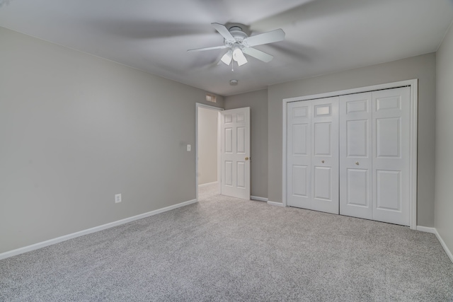 unfurnished bedroom featuring ceiling fan, carpet floors, and a closet