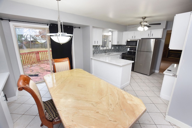 tiled dining space featuring ceiling fan and sink