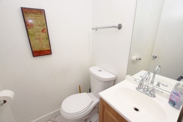 bathroom featuring tile patterned flooring, vanity, and toilet