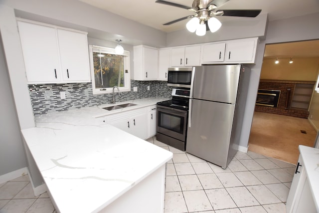 kitchen with white cabinetry, sink, ceiling fan, and appliances with stainless steel finishes