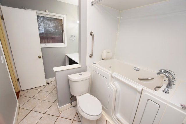 bathroom featuring tile patterned flooring, toilet, a bathing tub, and vanity