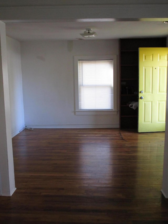 unfurnished room featuring dark hardwood / wood-style flooring