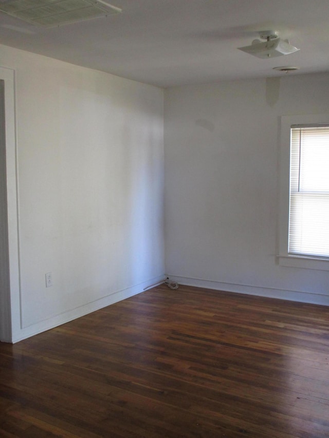 empty room with dark wood-type flooring