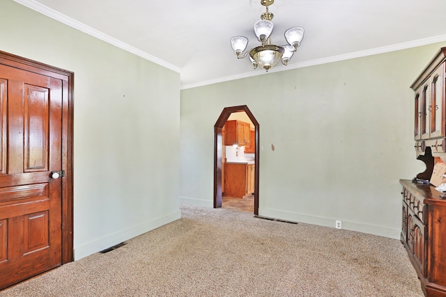 interior space featuring a notable chandelier, crown molding, and light carpet