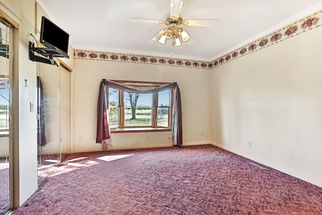 spare room with carpet flooring and ceiling fan