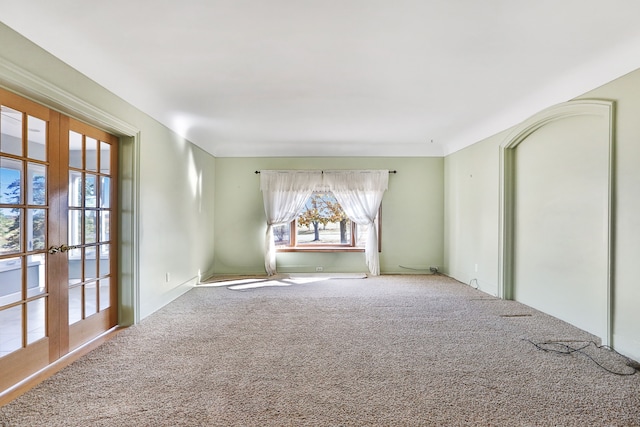 empty room with french doors and carpet floors