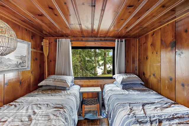 bedroom with wood walls and wooden ceiling