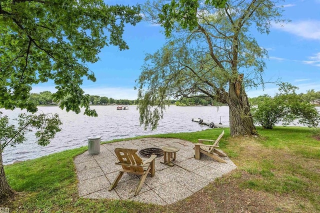 view of patio featuring a water view and an outdoor fire pit