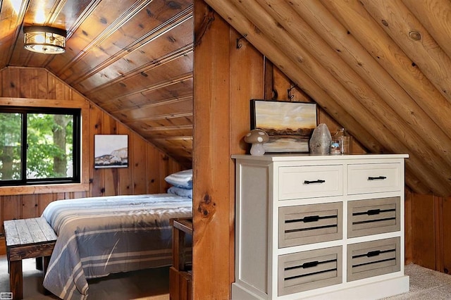 bedroom with carpet flooring, wood walls, wooden ceiling, and vaulted ceiling