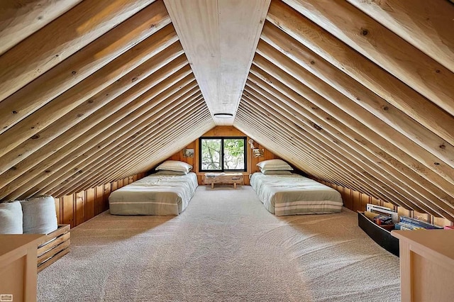 unfurnished bedroom featuring carpet and lofted ceiling