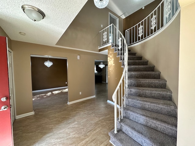 staircase featuring an inviting chandelier