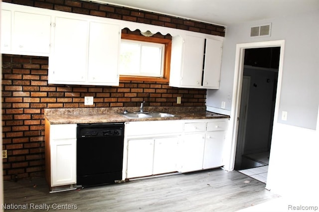 kitchen with dishwasher, light hardwood / wood-style floors, white cabinetry, and sink