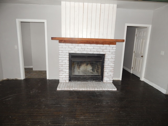 interior details featuring hardwood / wood-style floors and a brick fireplace