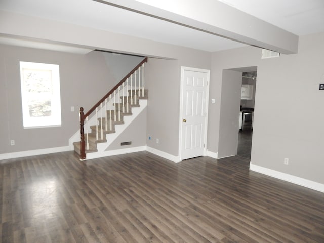 unfurnished living room featuring dark wood-type flooring