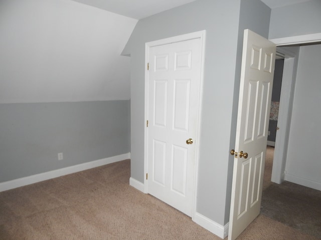 bonus room with carpet floors and vaulted ceiling