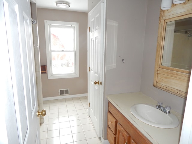 bathroom featuring tile patterned flooring and vanity