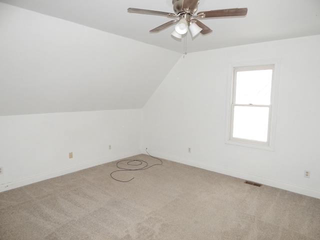 bonus room with light carpet, vaulted ceiling, and ceiling fan