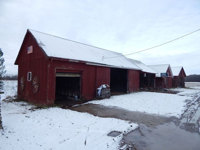 snow covered structure featuring a garage