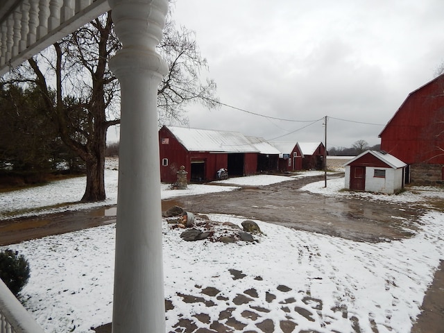 yard layered in snow with an outdoor structure