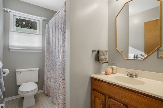 bathroom with toilet, vanity, and tile patterned flooring