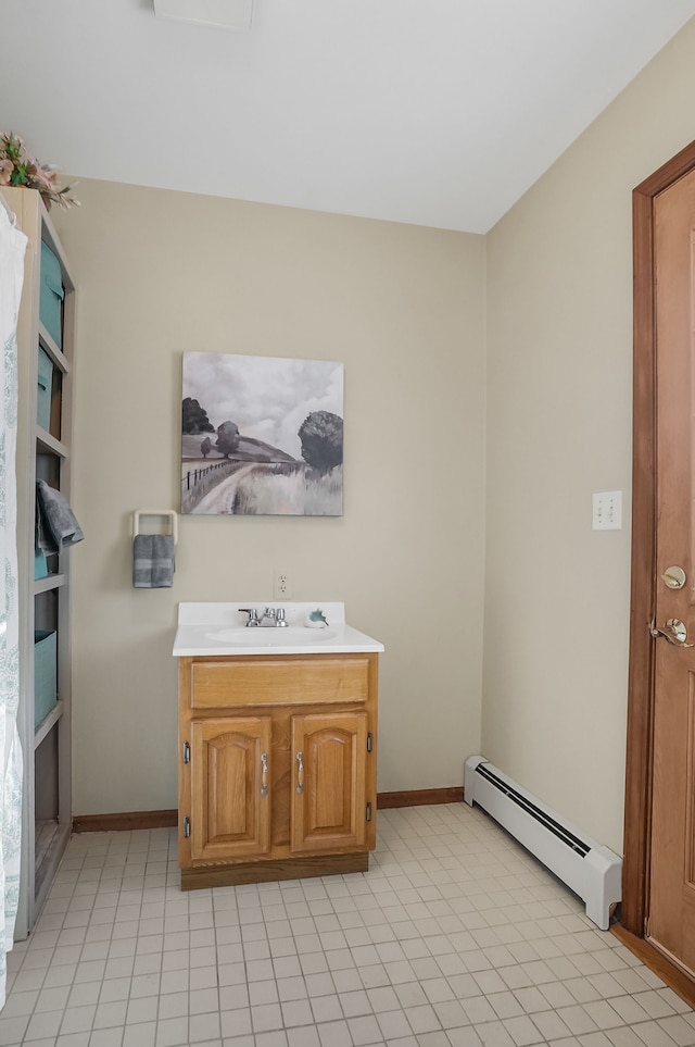 bathroom featuring baseboard heating and vanity