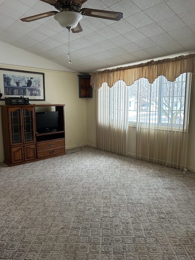 unfurnished living room with carpet, vaulted ceiling, and ceiling fan