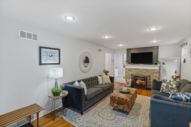 living room featuring a fireplace and hardwood / wood-style floors