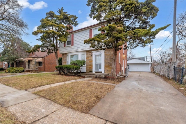 view of front facade with a garage, a front lawn, and an outdoor structure