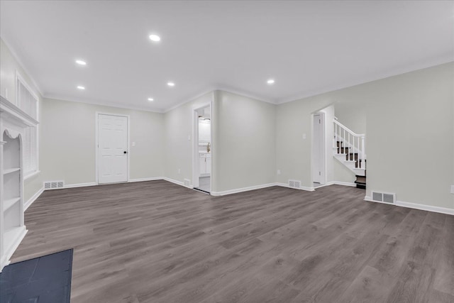 unfurnished living room featuring wood-type flooring and ornamental molding