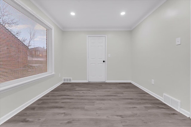 spare room with crown molding and hardwood / wood-style flooring