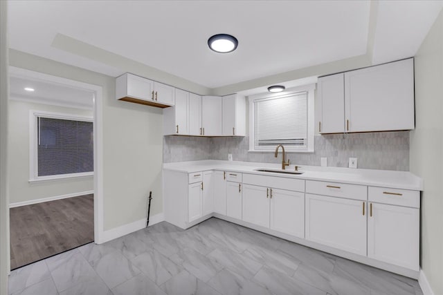 kitchen with white cabinetry and sink