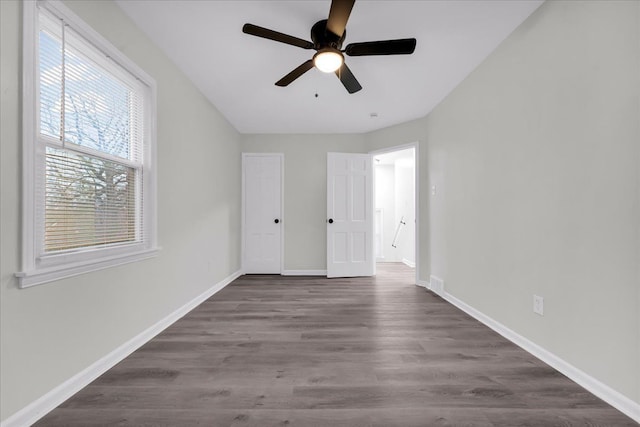 unfurnished bedroom with dark hardwood / wood-style floors and ceiling fan