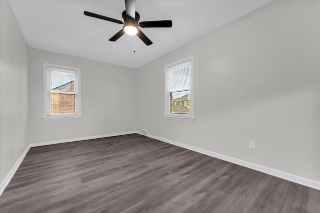 spare room featuring dark hardwood / wood-style floors and ceiling fan