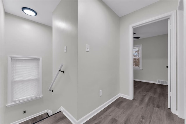 corridor with hardwood / wood-style floors