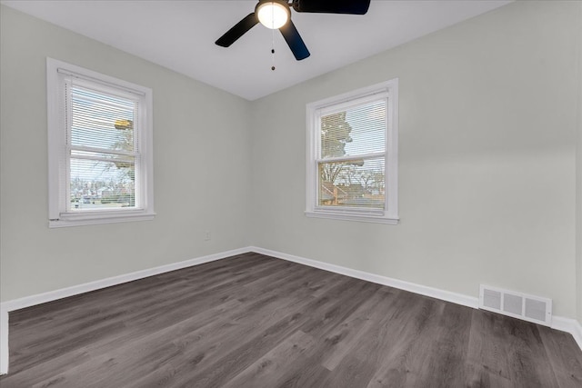 empty room with ceiling fan and dark hardwood / wood-style floors