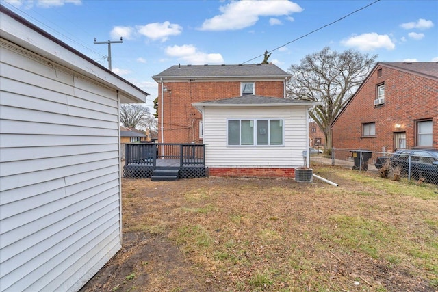 back of house with a lawn and a wooden deck